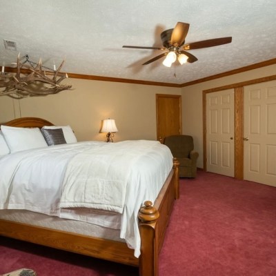 a bedroom with a bed and desk in a room